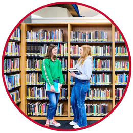Two students chatting in the Library
