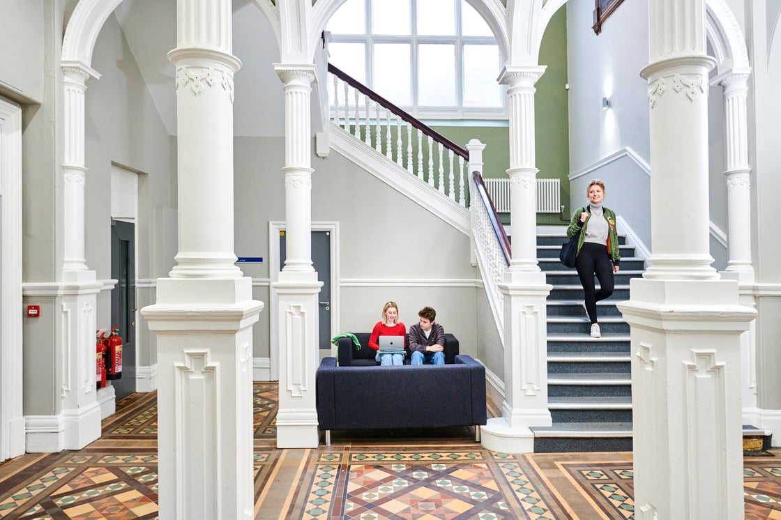 Student coming down stairs in the Grade-II listed building Culture Lab inside the the Grand Assembly Room building 