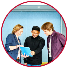 Colleague and two students looking at brochure