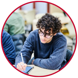 Student working at desk with iPad and pencil