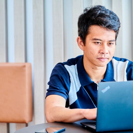 Student sat at laptop in Kings Gate