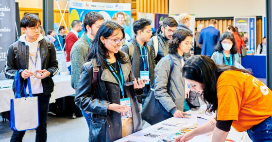 Students around a table at a recruitment fair