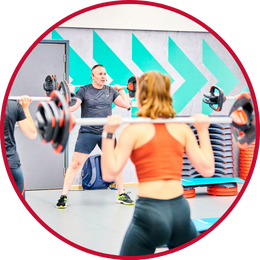 Students in a fitness class with instructor in front