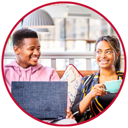 Two students sat in The Grand with laptop and cup of coffee