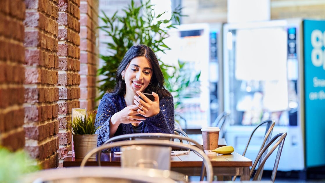 Student on her phone in a campus café