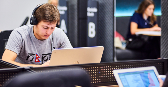 A student working on a laptop in the Library