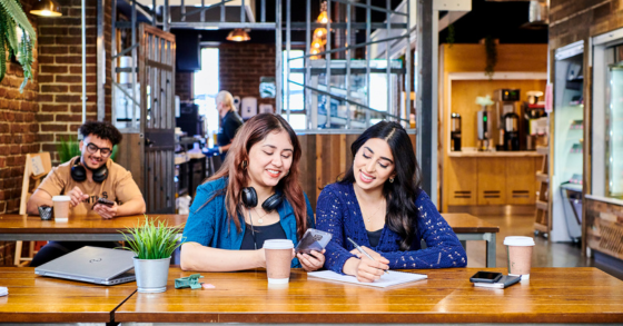 Two students working in a café on campus 