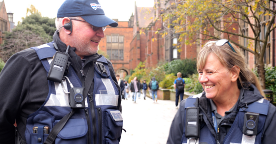 Two security officers on campus, smiling