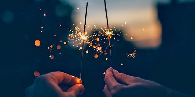 Two people holding sparklers