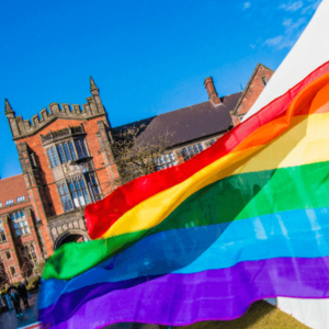 Student commnuities image of rainbow flag on campus in front of Arches