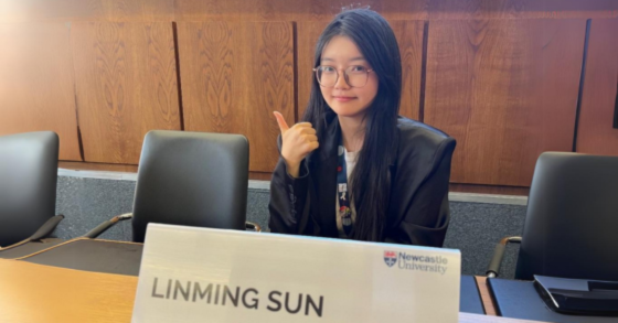 Image of Linming at a Student Council meeting giving a thumbs-up 