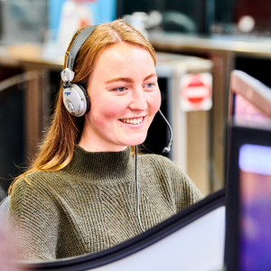 student with headphones on looking at a computer