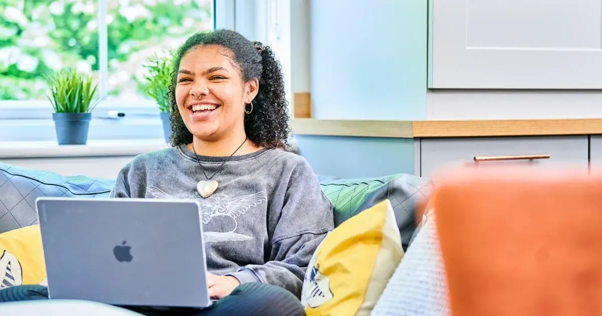 student-laughing-with-laptop