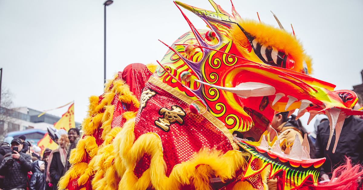 Side profile of a red and gold dragon costume featured during the 2023 Lunar New Year parade.
