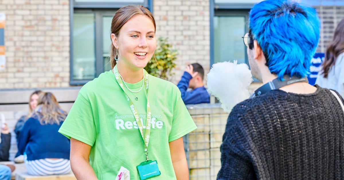 ResLife Student Assistant talking to a new student