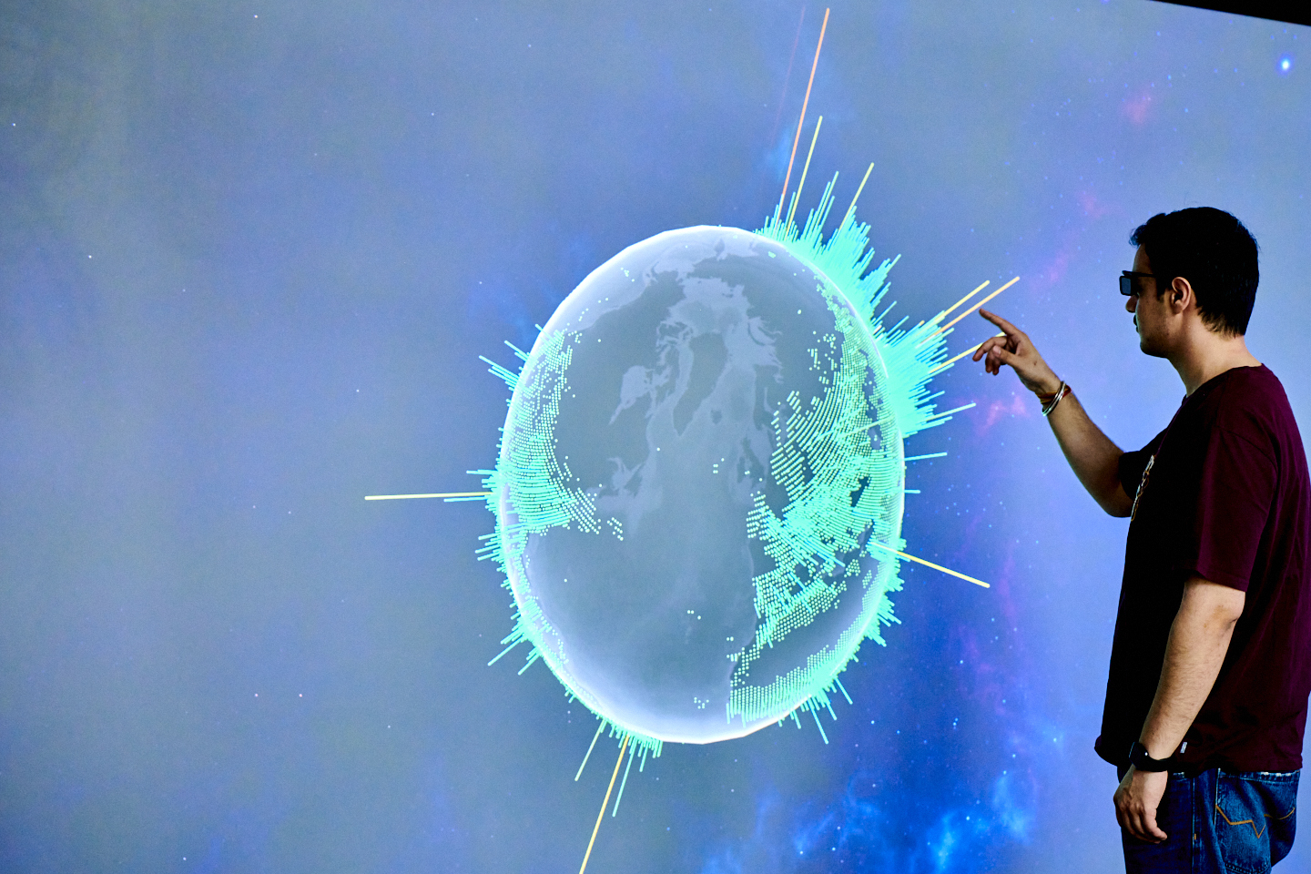 A student interacts with data on the data visualisation screen. The student is wearing special glasses which creates a better visual experience.